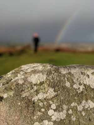 A rainbow behind granite.
