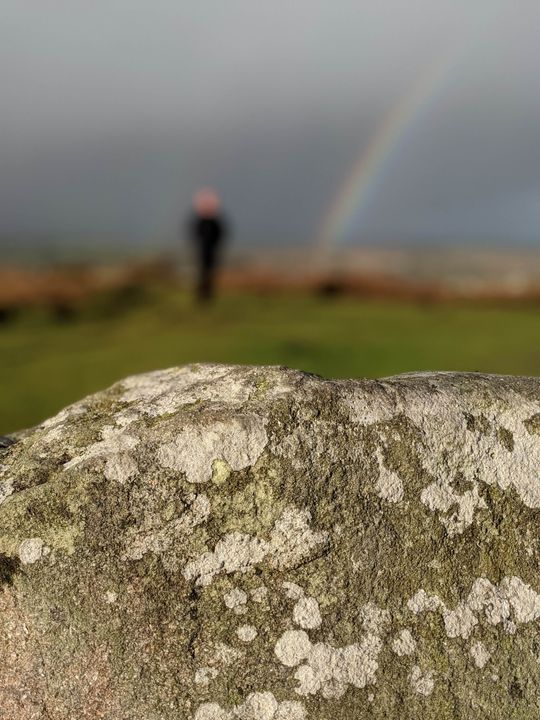 A rainbow behind granite.