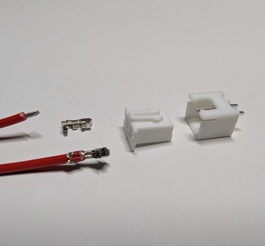 A JST connector. The long wing holds the insulator, the short wing holds the conductor.