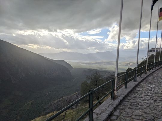 The view from Delphi to the Gulf of Corinth. I love the sun rays in the distance, with the contrast between the light there and the cloudliness up close.